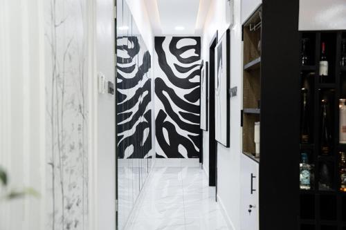 a hallway with a black and white patterned wall at Brand New 2bed flat close to the beach with 2 balconies in Lekki