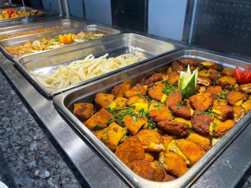 a buffet with several trays of food on a table at Golf Residence- Families and Couples Only in Hammam Sousse