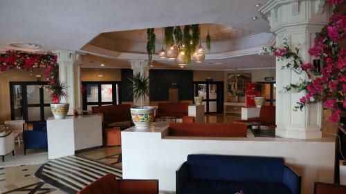 a lobby of a hotel with couches and flowers at Golf Residence- Families and Couples Only in Hammam Sousse