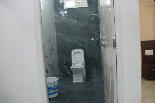 a small bathroom with a toilet and a shower at Ideal Residency in Gulbarga
