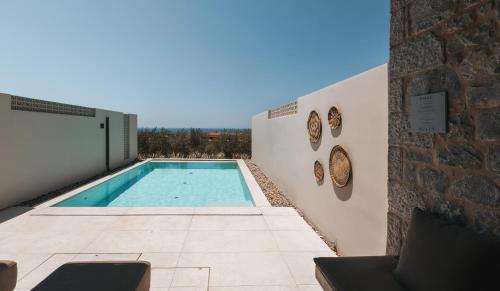 a swimming pool on the side of a building at Castor & Pollux in Kotrónion
