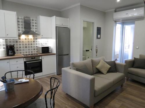 a living room with a couch and a table at Rodonas-Apartments in Volissos
