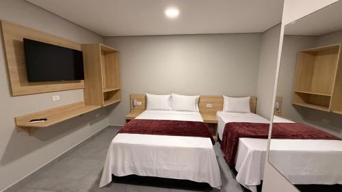 Postel nebo postele na pokoji v ubytování Hotel Haven Guarulhos