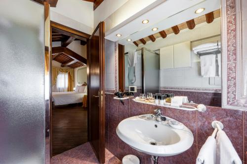 a bathroom with a sink and a mirror at Hotel Colombina in Venice