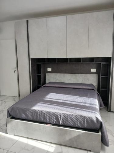 a bed in a bedroom with white cabinets at LaVenere da Gigi e Patty in San Salvo