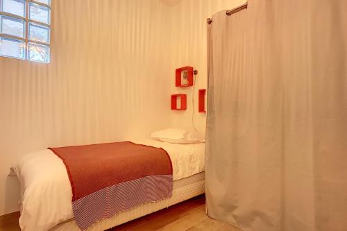 a bedroom with a bed and a window at Cours Massena on Marché Provencal in Antibes