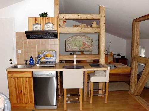 a kitchen with a wooden table and a sink at Apartment in Putbus II in Putbus