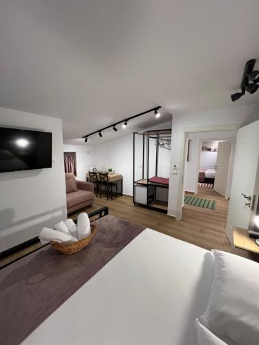 a room with a bed and a living room at Doctor's House in Tepelenë