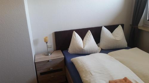 a hotel room with a bed with pillows on it at Hotel Deutsches Haus Francop in Hamburg