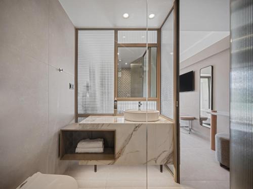 a bathroom with a sink and a mirror at Creta Star Hotel - Adults Only in Skaleta