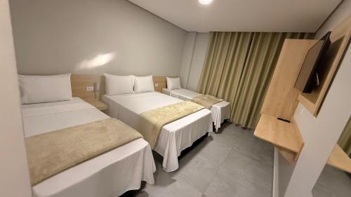 Postel nebo postele na pokoji v ubytování Hotel Haven Guarulhos