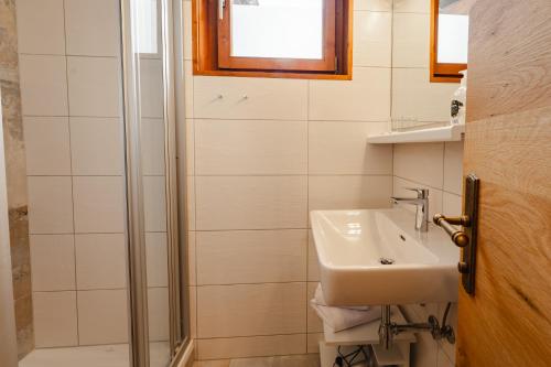 a bathroom with a sink and a shower at Glautschhof in Weissensee