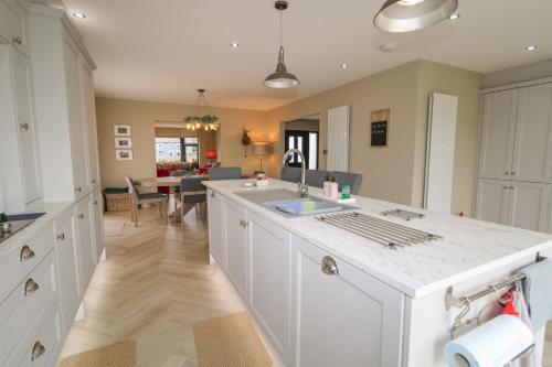a kitchen with a sink and a counter top at Clarmes House in Limavady