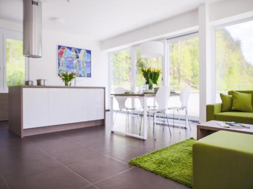a living room with a green couch and a table at Villa Irene in Trenčianske Teplice