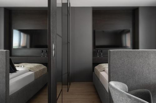 a bedroom with two beds and two mirrors at Scala Apartamenty by Moderna Profit- Łąkowa 60E in Gdańsk