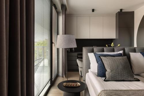 a living room with a couch and a large window at Scala Apartamenty by Moderna Profit- Łąkowa 60E in Gdańsk