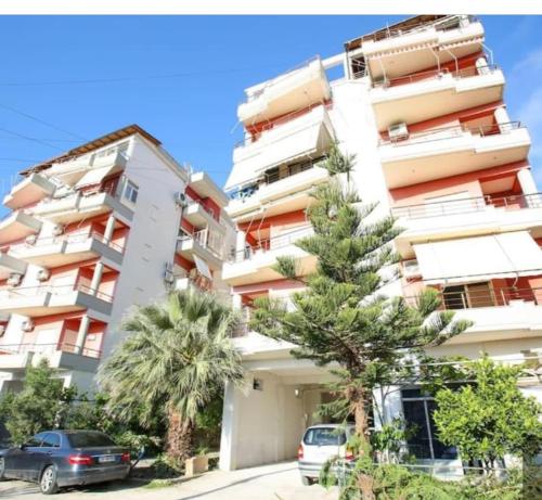 a tall apartment building with cars parked in front of it at Vlora Getaway Comfort & Style in Vlorë