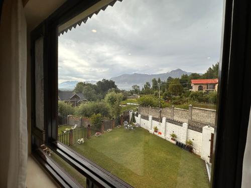 a view of a yard from a window of a house at Silver Woods- A Boutique Cottage in Srinagar
