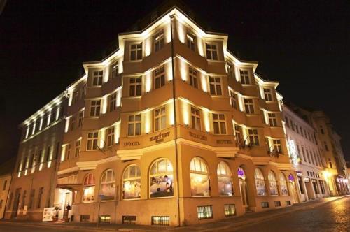a large building is lit up at night at Zlatý Lev Žatec in Žatec