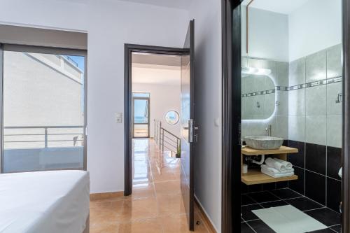 a bathroom with a sink and a mirror at Kalamaki Del Mar in Chania
