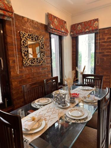 a dining room with a table with dishes on it at Silver Woods- A Boutique Cottage in Srinagar