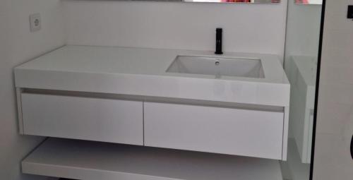 a white sink in a white cabinet in a kitchen at Aveiro Central Appartment in Aveiro