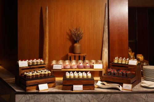 a display of different types of desserts on a table at Mandarin Oriental, Jakarta in Jakarta
