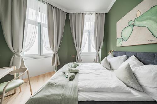 a bedroom with a bed with a teddy bear on it at HOME1 - District Twelve Boutique Hostel in Vienna