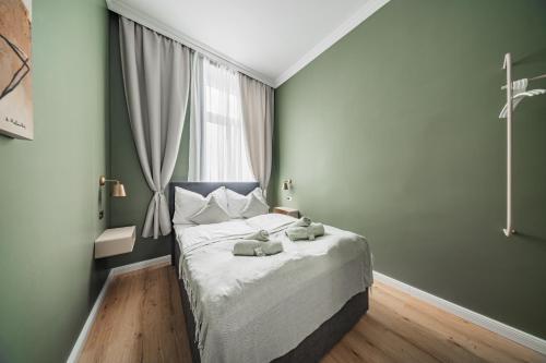 a bedroom with a bed with two stuffed animals on it at HOME1 - District Twelve Boutique Hostel in Vienna