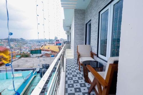 a balcony with a view of a city at Cozy Heaven in Ooty