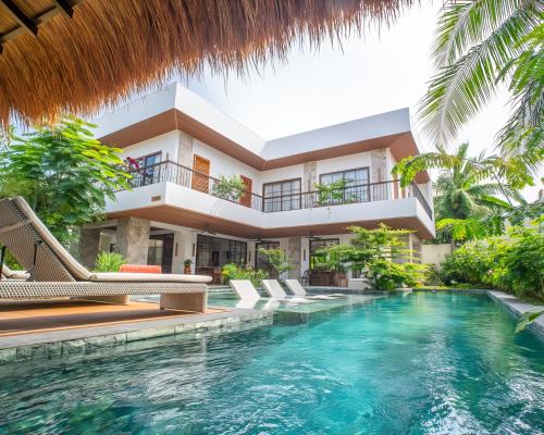 an exterior view of a villa with a swimming pool at Villa Sima - Tropical Elegance in central Panglao in Panglao