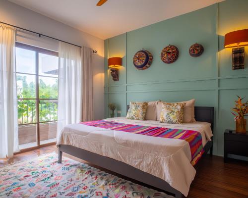 a bedroom with a bed with two plates on the wall at Villa Sima - Tropical Elegance in central Panglao in Panglao