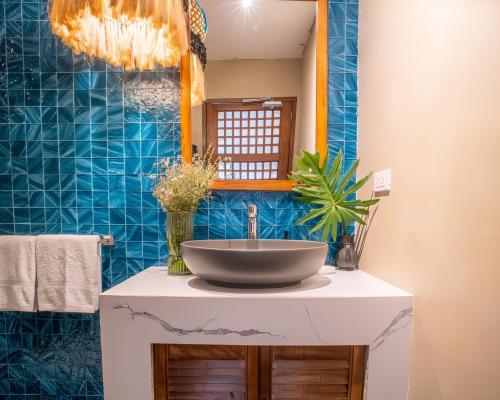 a bathroom with a sink and a mirror at Villa Sima - Tropical Elegance in central Panglao in Panglao