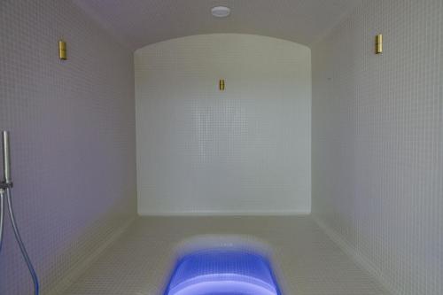 a bathroom with a blue tub in a room at Domaine de Verchant & Spa - Relais & Châteaux in Montpellier