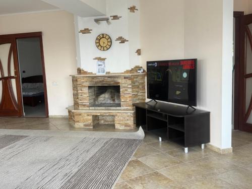 a living room with a tv and a fireplace at Vila ,Квартира на земле с террасой in Chişinău