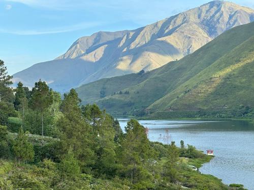 a view of a lake with mountains in the background at Slash homestay in Silimapuluh