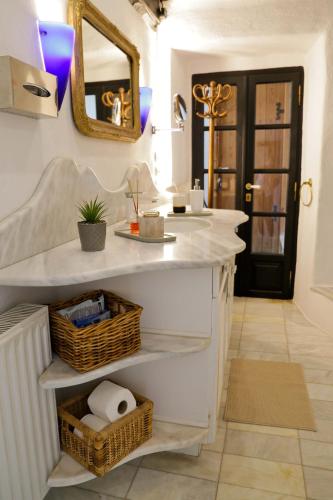 a bathroom with a sink and a mirror at Villa Blanca Koukourava in Makrinitsa