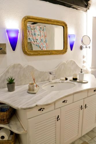 a bathroom with a sink and a mirror at Villa Blanca Koukourava in Makrinitsa