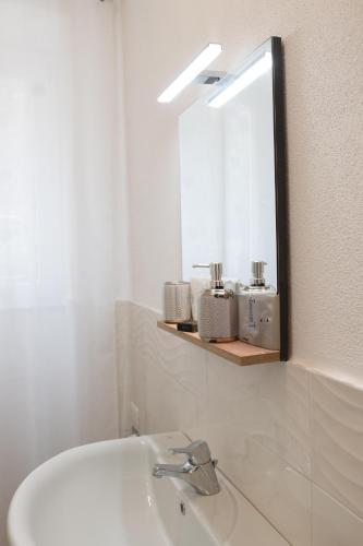 a bathroom with a sink and a mirror at Alba apartments in Biassa