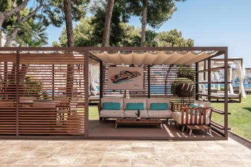 a pergola with chairs and a table at Hotel de Mar Gran Meliá - Adults Only - The Leading Hotels of the World in Illetas