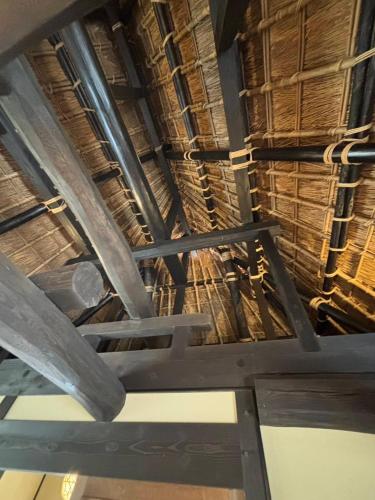 a ceiling of a building with straw roofs at Miyama Resort Kayabuki-tei - Matsuba's Inn in Nantan city