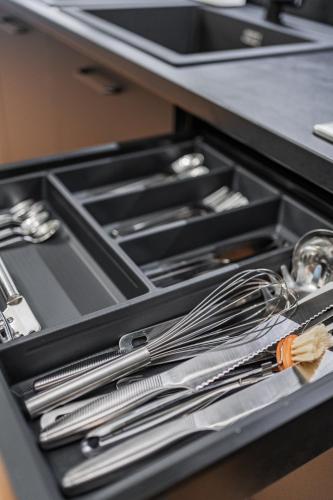 a drawer filled with utensils in a kitchen at HOME1 - District Twelve Boutique Hostel in Vienna