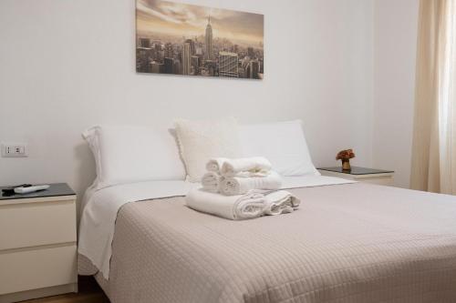 a bedroom with a bed with towels on it at Alba apartments in Biassa