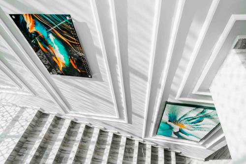 two pictures on the ceiling of a room at Joy Inn Hotel in Dar es Salaam