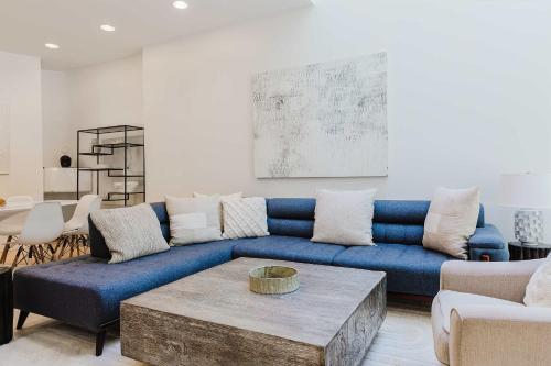 a living room with a blue couch and a table at Private Beautiful Townhome w Zen Garden in New York
