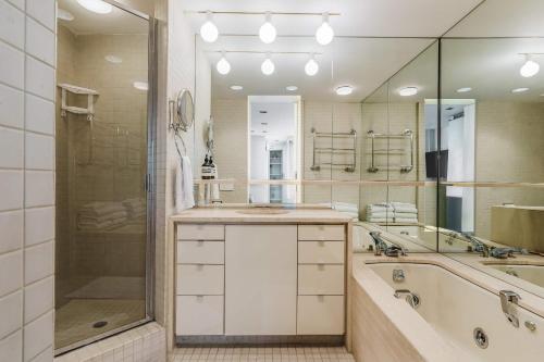 a bathroom with a tub and a sink and a shower at Private Beautiful Townhome w Zen Garden in New York