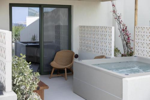 a hot tub in the middle of a house at Cavo Marelia in Amoopi