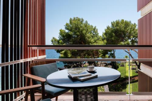a table and chairs on a balcony with a view of the water at Hotel de Mar Gran Meliá - Adults Only - The Leading Hotels of the World in Illetas