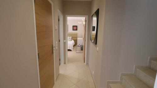 a hallway leading to a room with a bathroom at Beautiful Portuguese Villa Casa Das Buganvillas 3 Bedrooms Close To Praca Private Pool Vale Do Lobo in Vale do Lobo