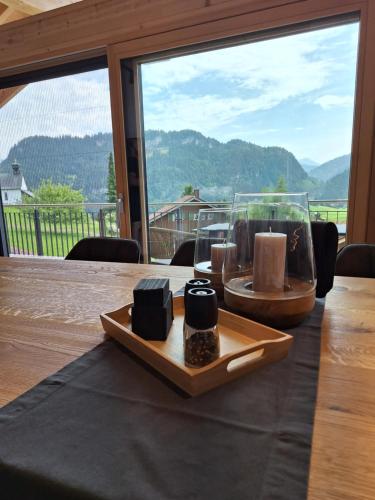 a table with candles on it with a view of a mountain at Beim Hofar - die neuen Ferienwohnungen in Obermaiselstein in Obermaiselstein
